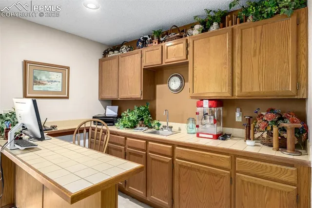 a kitchen with a wooden floor and cabinets