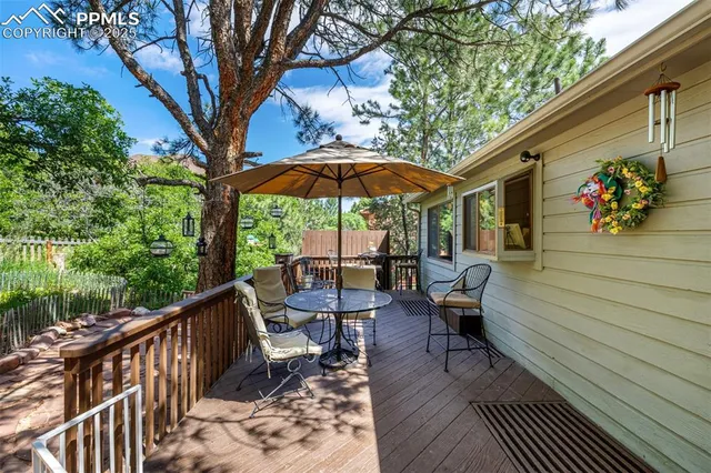 a view of balcony with wooden floor and outdoor seating
