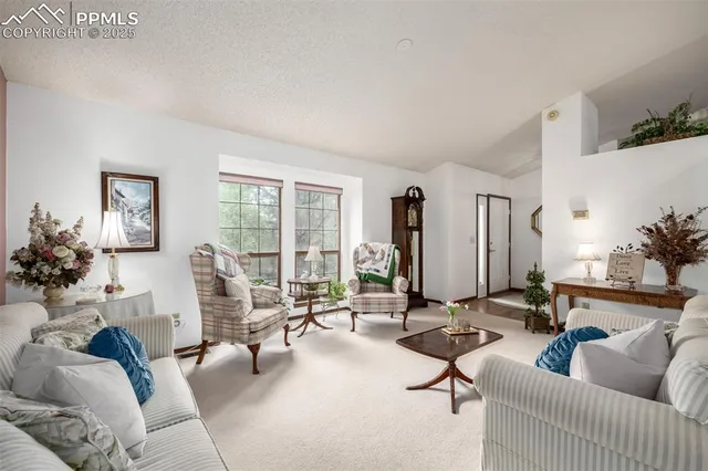 a living room with furniture gym equipment and a large window