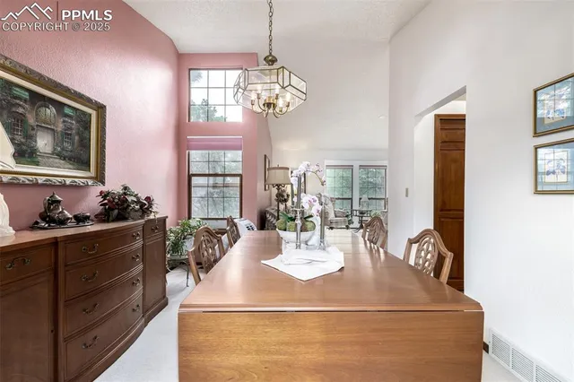 a view of a dining room with furniture and window