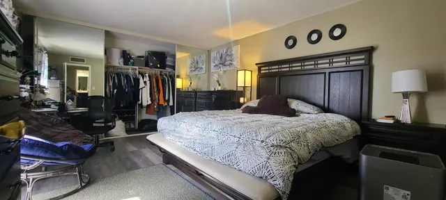 a bedroom with a bed and a mirror