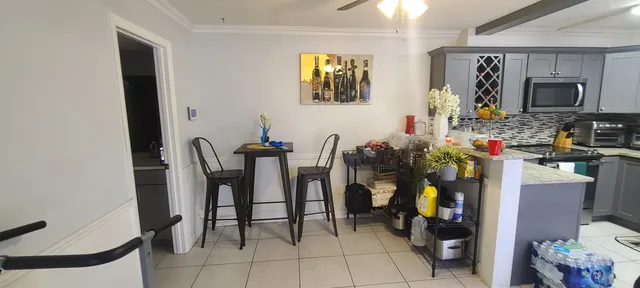 a view of a dining room with furniture and a chandelier
