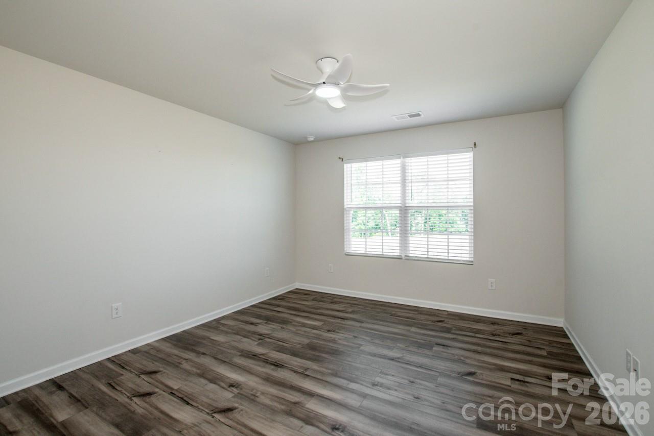 2742 Legacy Ridge Lane Catawba, NC 28609 - Photo 23 of 36 an empty room with wooden floor and windows