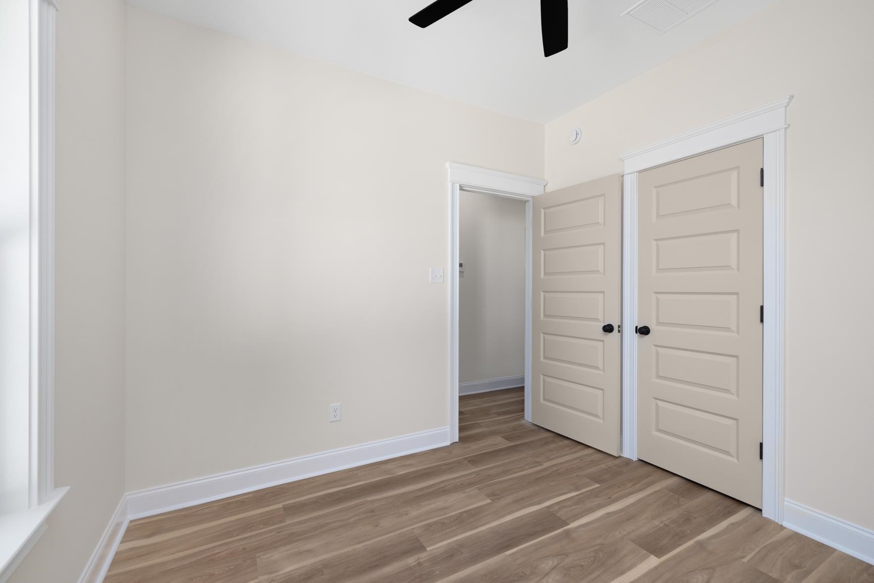 319 North Maple Street Covington, TN 38019 - Photo 25 of 32 Unfurnished bedroom with light wood-style floors, a ceiling fan, and a closet