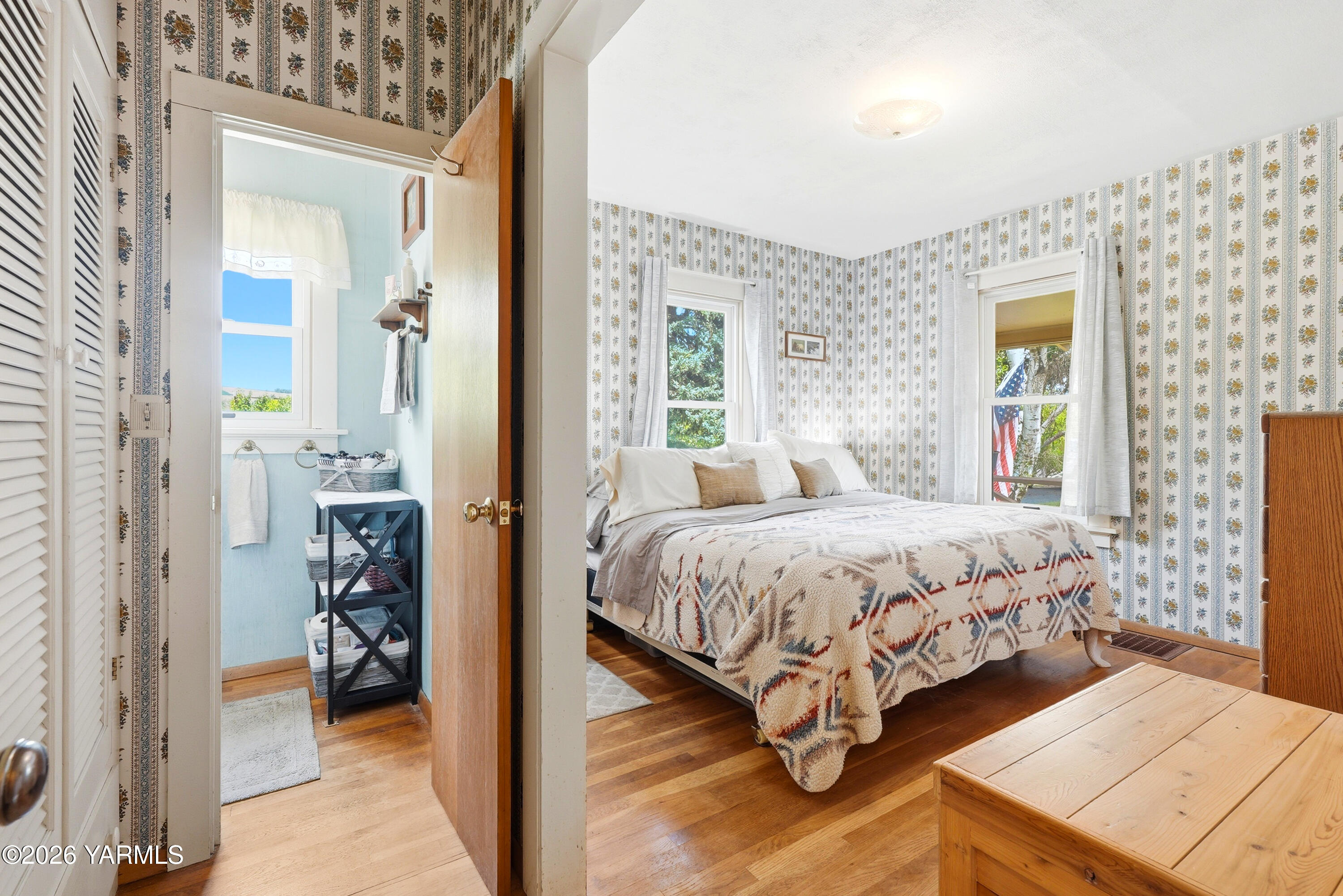 690 North Gleed Road Naches, WA 98937 - Photo 15 of 60 a spacious bedroom with a bed and a chandelier