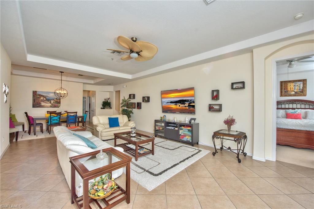 12859 Carrington Circle, Unit 3202 Naples, FL 34105 - Photo 1 of 28 a living room with furniture and a flat screen tv