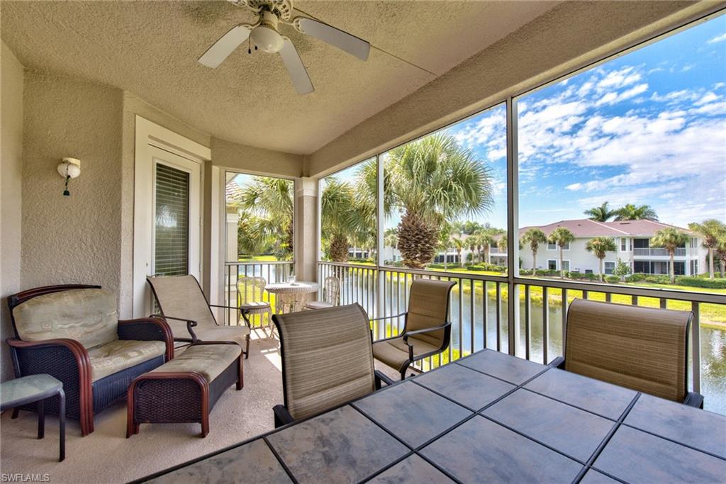 12859 Carrington Circle, Unit 3202 Naples, FL 34105 - Photo 17 of 28 a living room with furniture and a floor to ceiling window