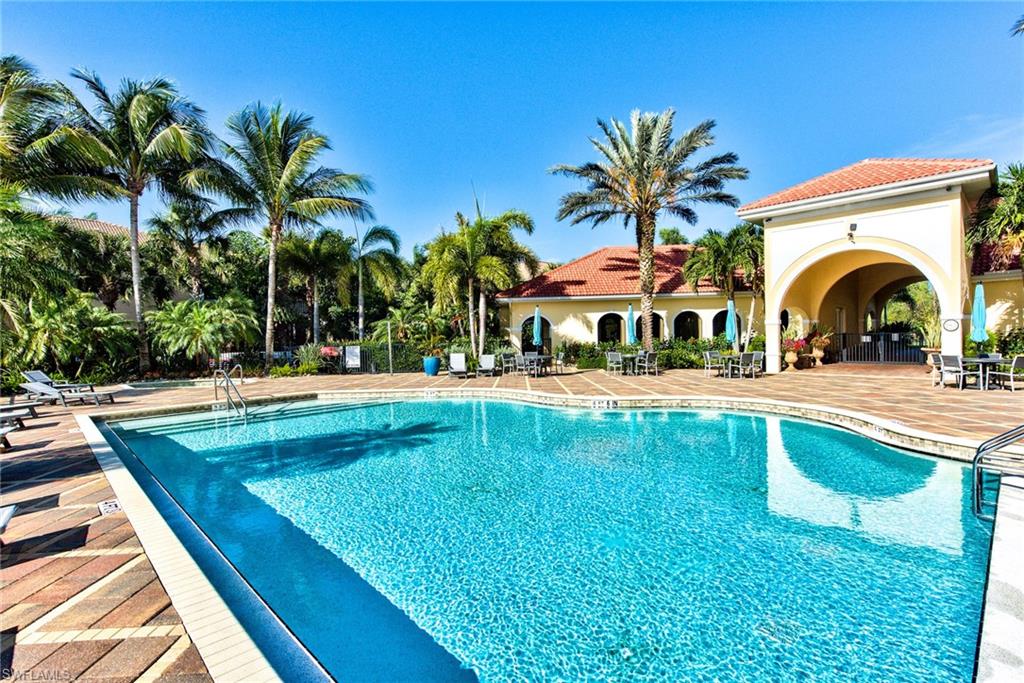 12859 Carrington Circle, Unit 3202 Naples, FL 34105 - Photo 23 of 28 a view of swimming pool with a table and chairs