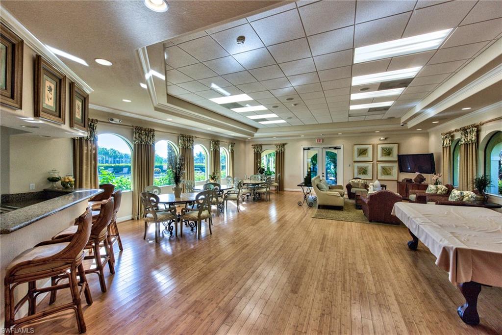 12859 Carrington Circle, Unit 3202 Naples, FL 34105 - Photo 27 of 28 a view of a dining room with furniture window and wooden floor
