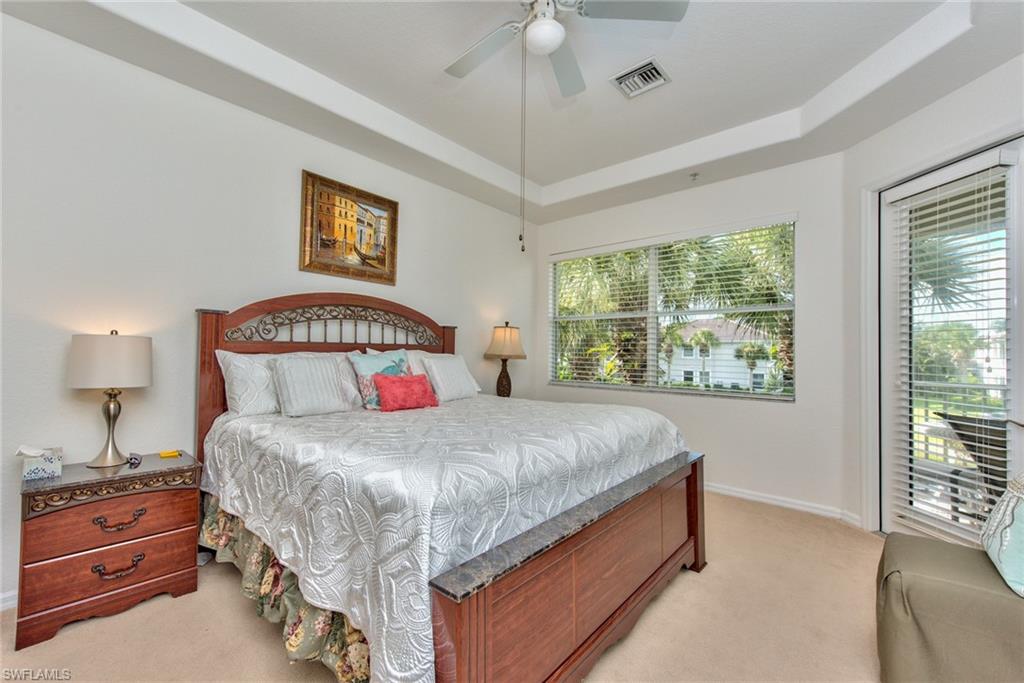 12859 Carrington Circle, Unit 3202 Naples, FL 34105 - Photo 8 of 28 a bedroom with a bed and a window