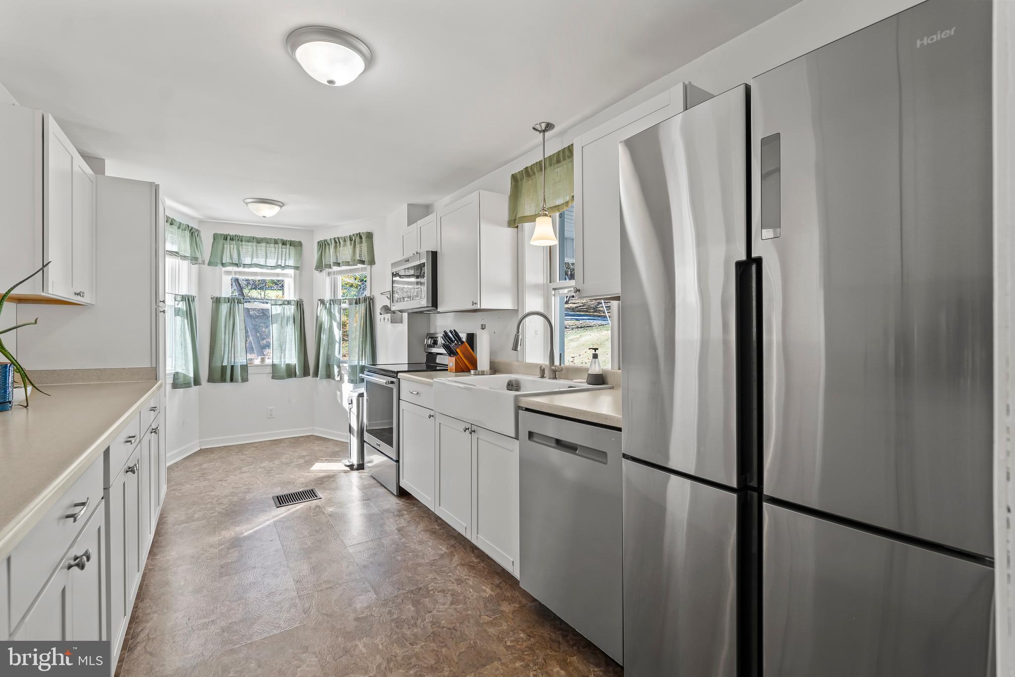 13608 Maryland Avenue Blue Ridge Summit, PA 17214 - Photo 19 of 80 a kitchen with stainless steel appliances a refrigerator sink and cabinets