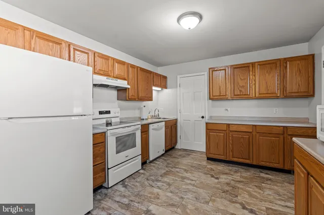 a room with a dresser a window and mirror