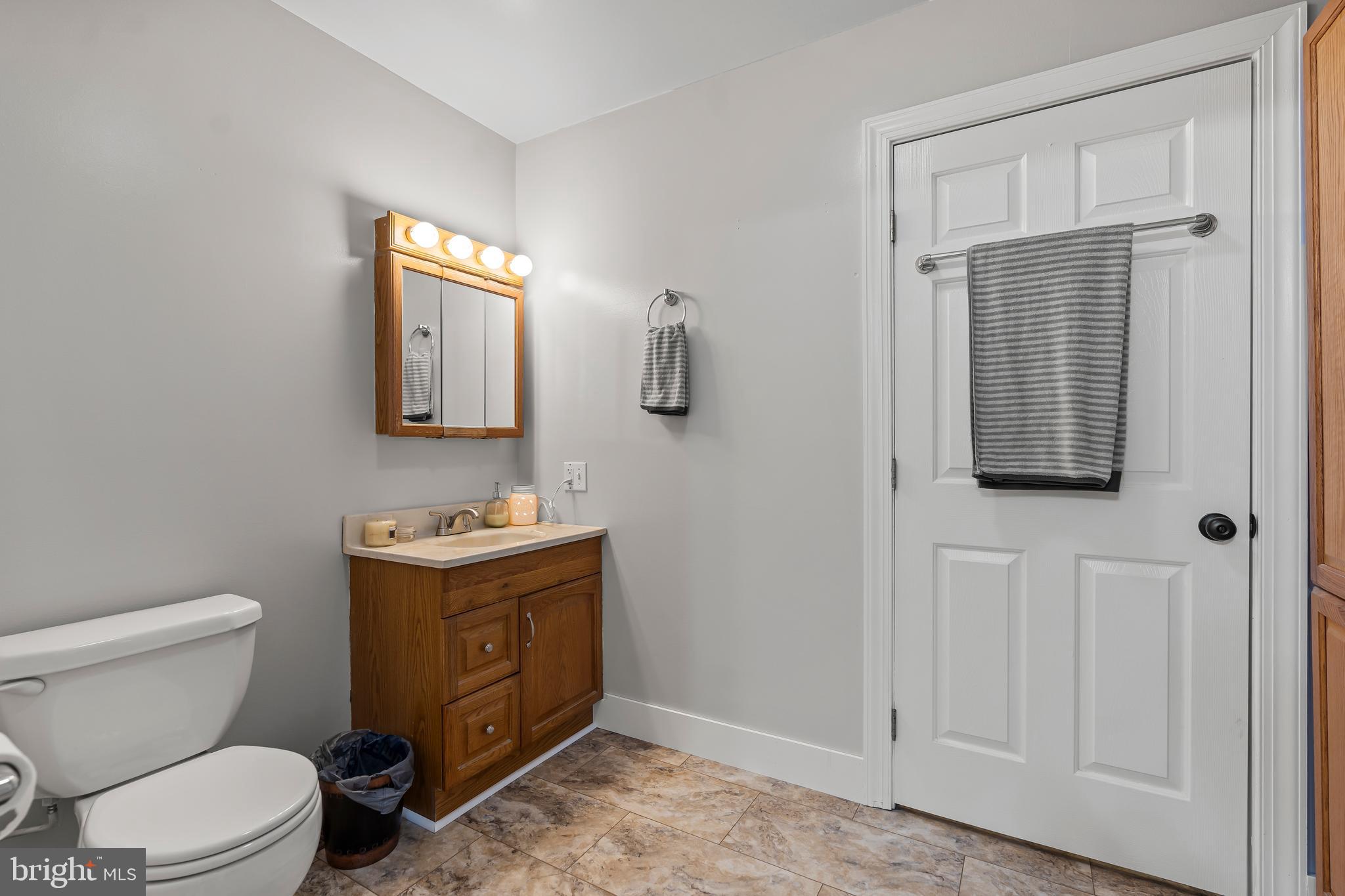 13608 Maryland Avenue Blue Ridge Summit, PA 17214 - Photo 32 of 80 a bathroom with a toilet sink and mirror