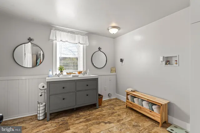 a view of a backyard with table and chairs and potted plants and large trees