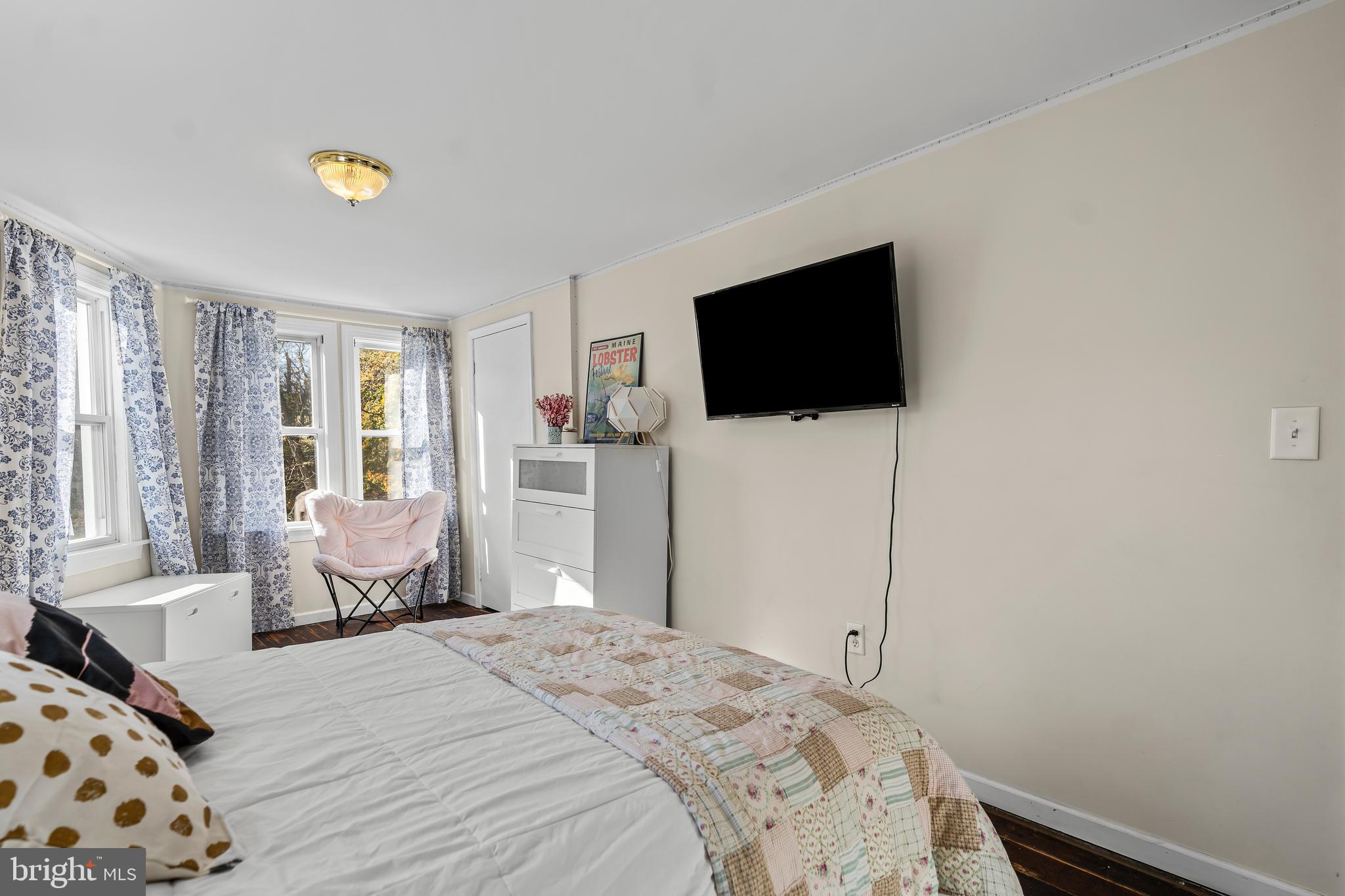 13608 Maryland Avenue Blue Ridge Summit, PA 17214 - Photo 48 of 80 a bedroom with a bed a flat screen tv and a couch