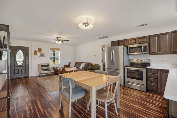 a kitchen with stainless steel appliances a stove sink microwave and cabinets