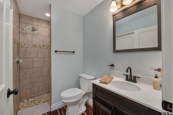 a large living room with stainless steel appliances kitchen island granite countertop furniture and a kitchen view