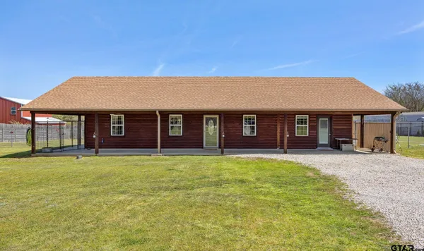 a living room with furniture a clock and a rug