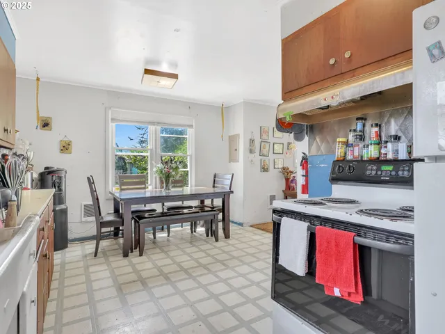 a kitchen with stainless steel appliances granite countertop a stove a sink and a dining table