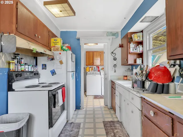 a kitchen with stainless steel appliances granite countertop a sink and a refrigerator