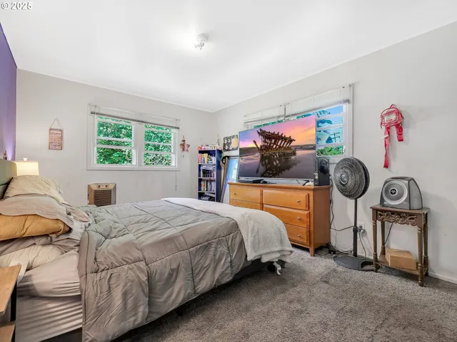 a bedroom with a bed and a view of walk in closet
