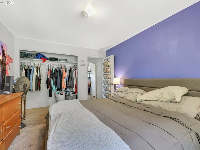 a bedroom with a bed and a desk