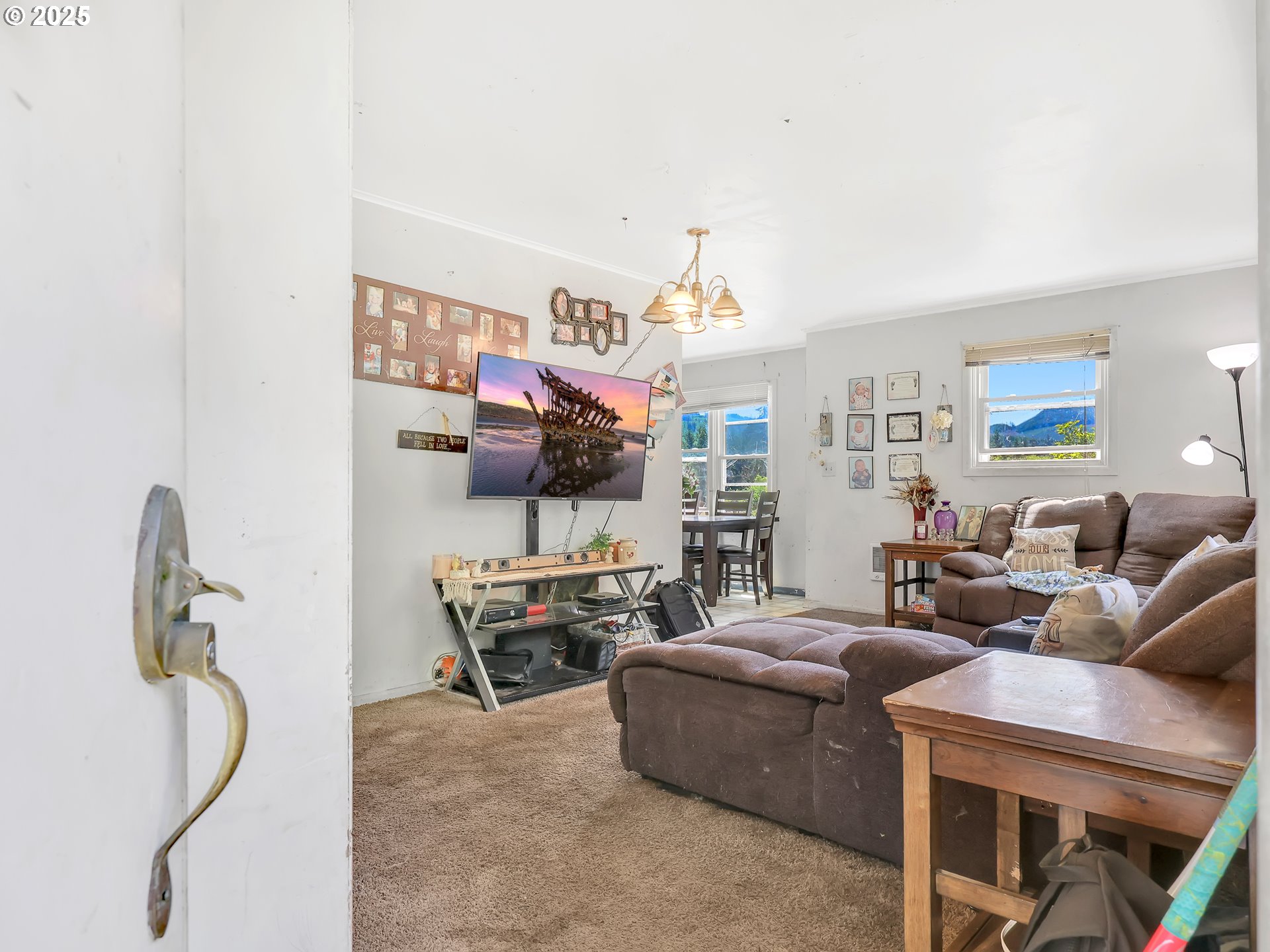 43018 Hillcrest Loop Astoria, OR 97103 - Photo 3 of 27 a living room with furniture a flat screen tv and a window