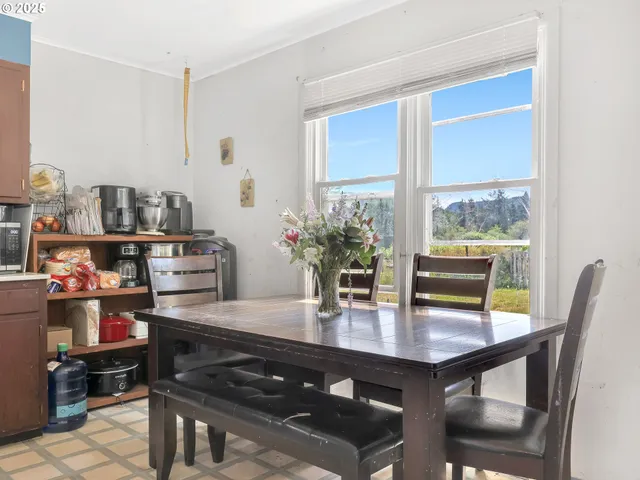 a dining room with furniture and wooden floor