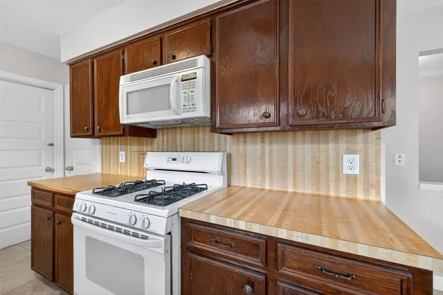 a kitchen with granite countertop cabinets and black appliances