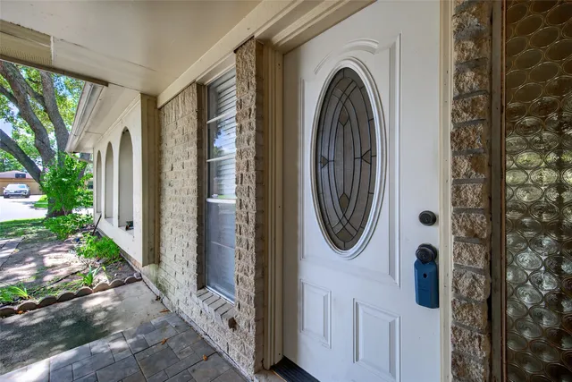 a view of a door with a fountain and a porch