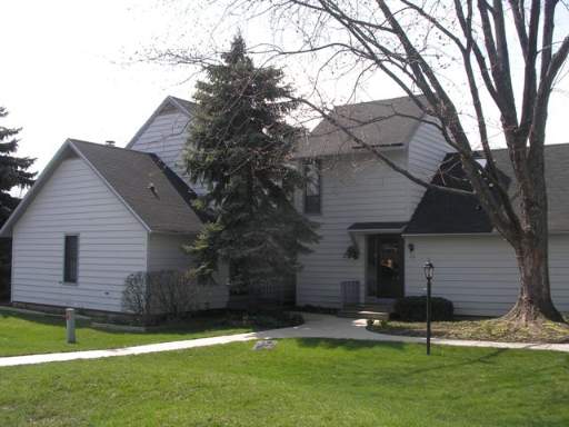 710 Chandler Road, Unit 710 Gurnee, IL 60031 - Photo 1 of 1 a view of a house with a yard and a large tree