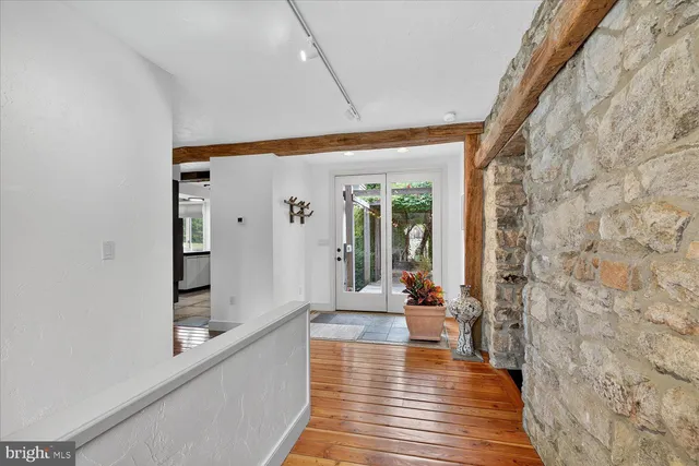 a room with stainless steel appliances kitchen island granite countertop furniture and a view of kitchen