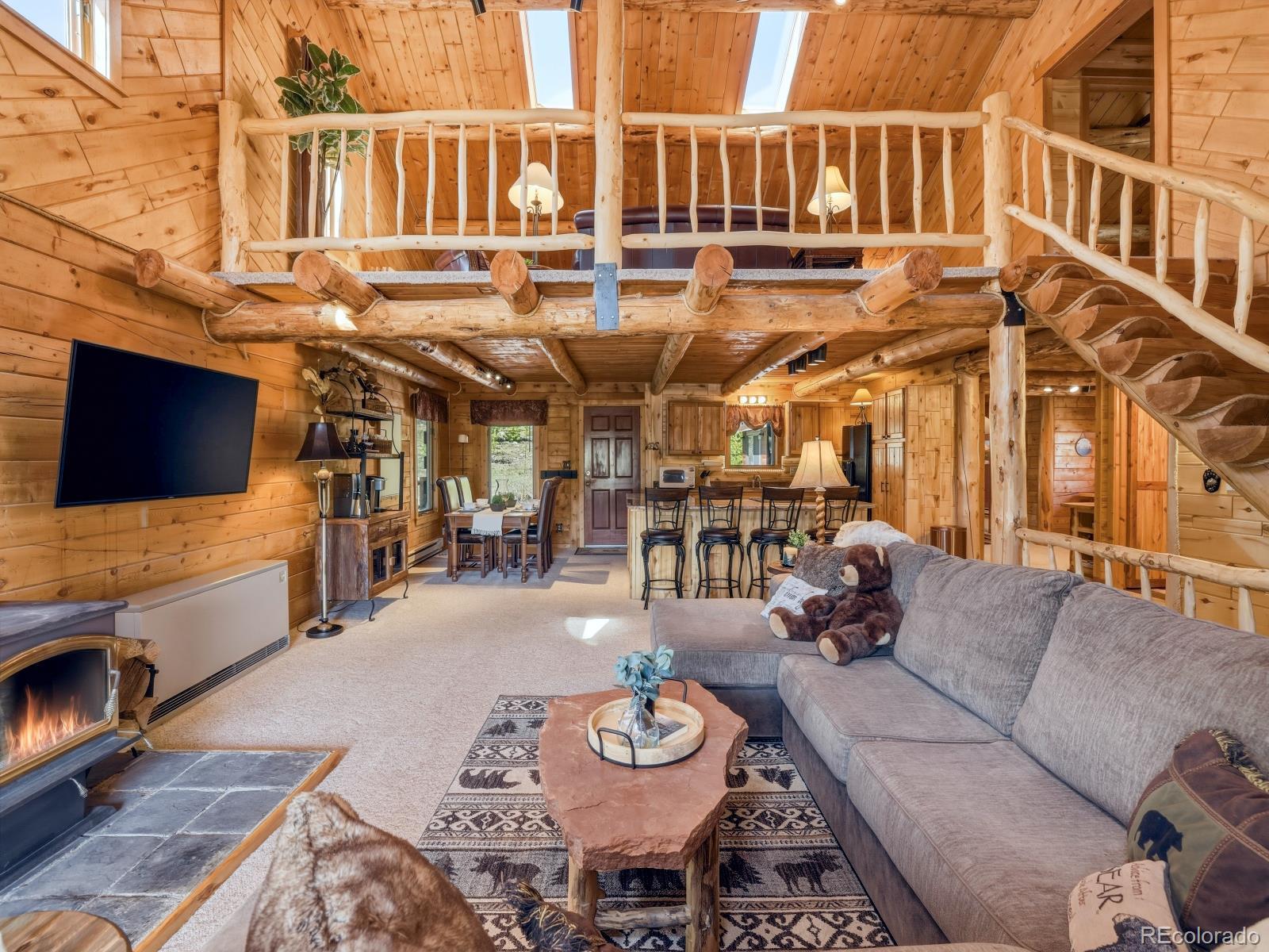 341 Anderson Road Walden, CO 80480 - Photo 21 of 50 a view of a patio with couches table and chairs with wooden floor