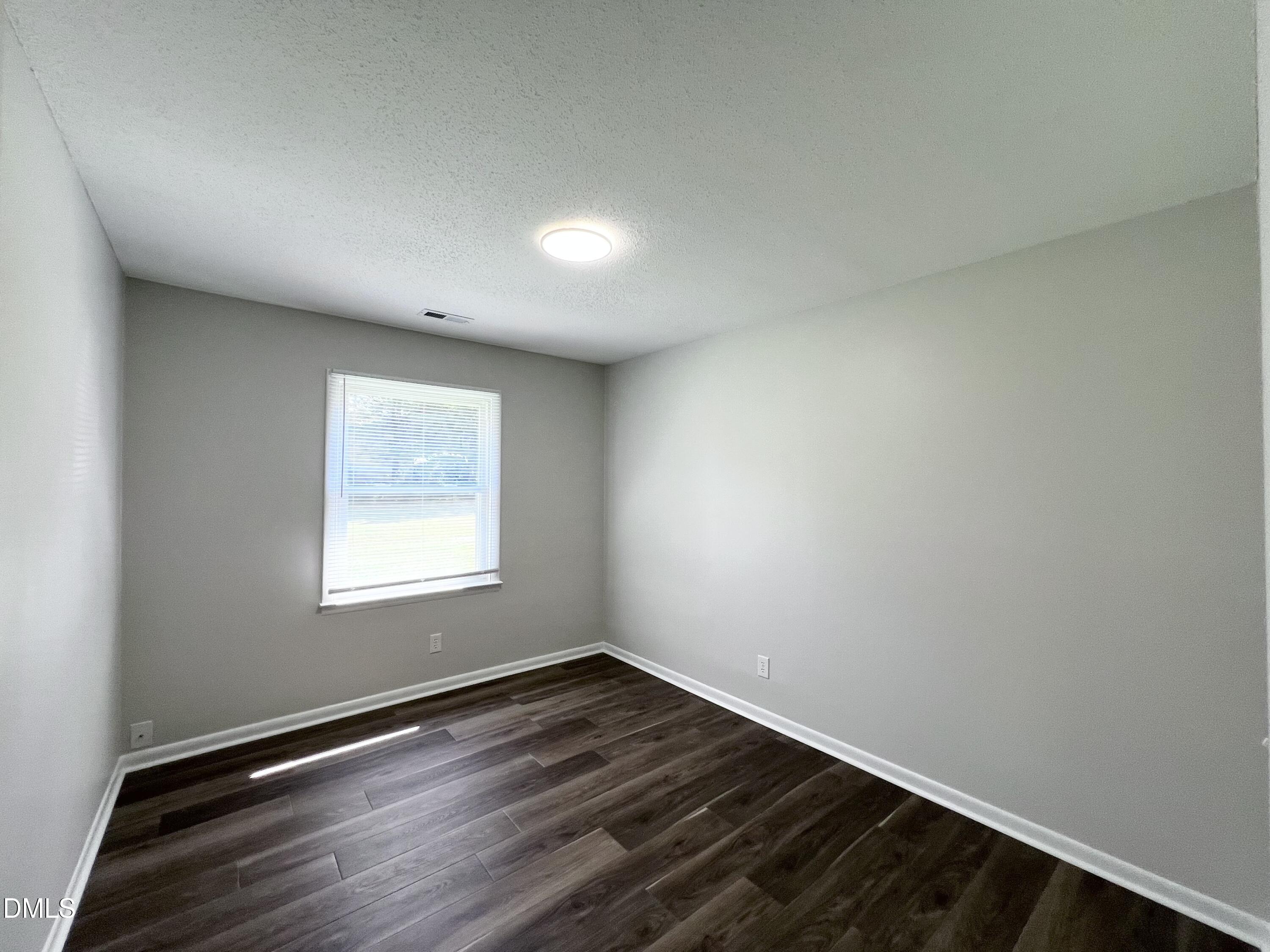 200 Infinity Road Durham, NC 27712 - Photo 14 of 32 an empty room with wooden floor and windows