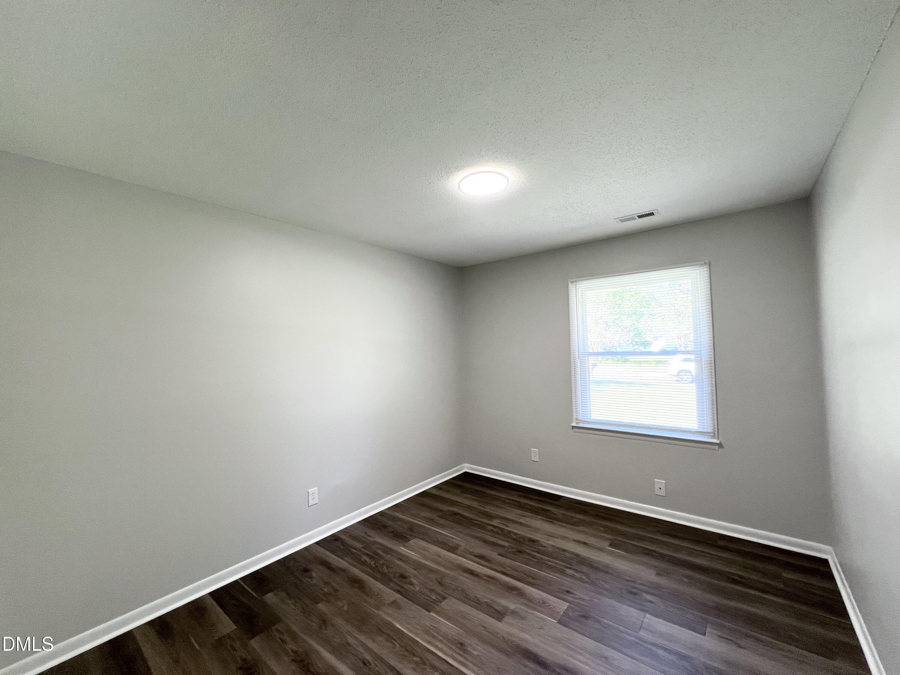 200 Infinity Road Durham, NC 27712 - Photo 17 of 32 an empty room with wooden floor and windows