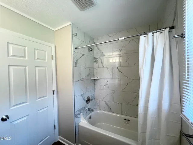 a bathroom with a shower curtain and a sink
