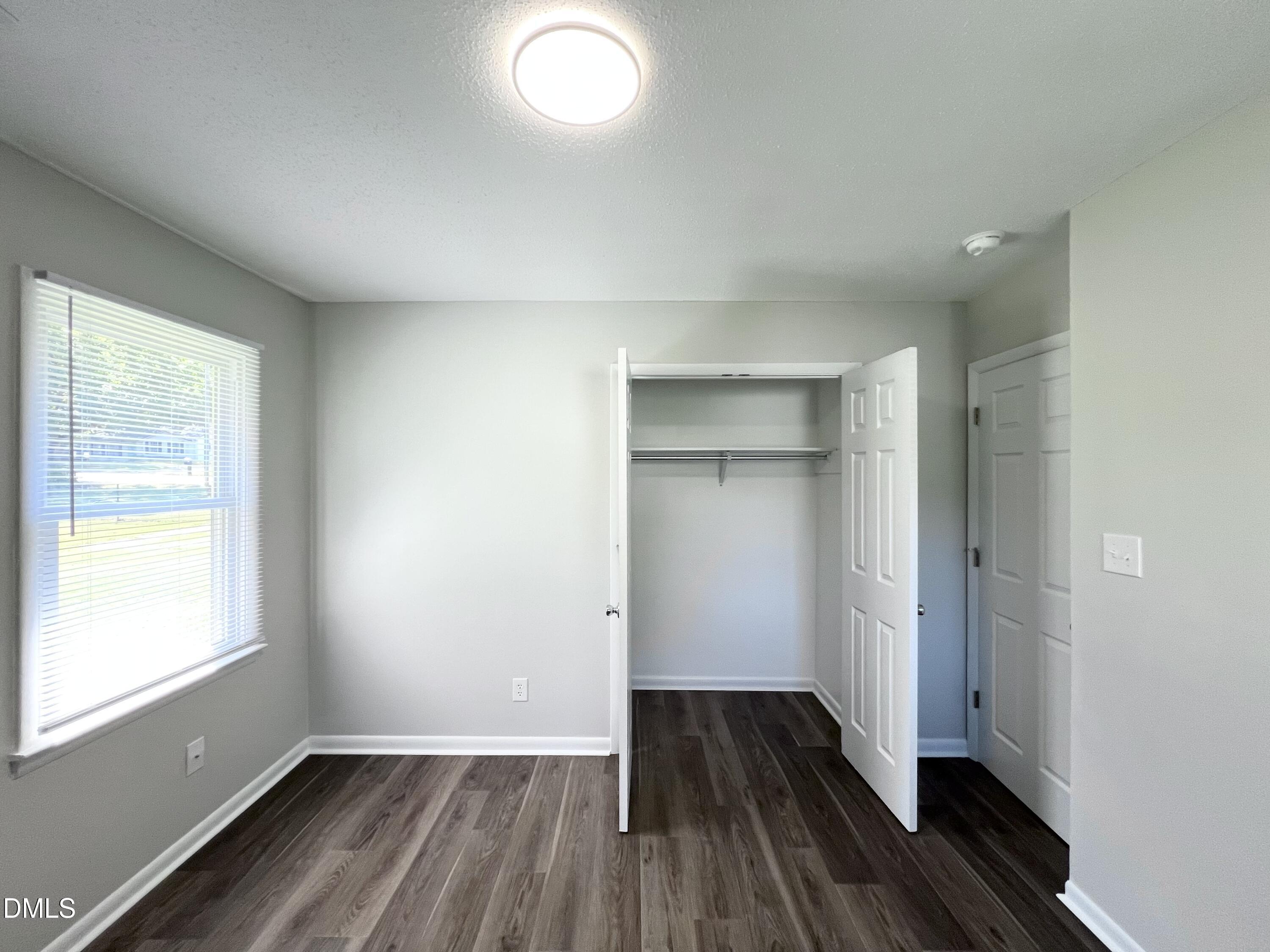200 Infinity Road Durham, NC 27712 - Photo 22 of 32 wooden floor in an empty room with a window