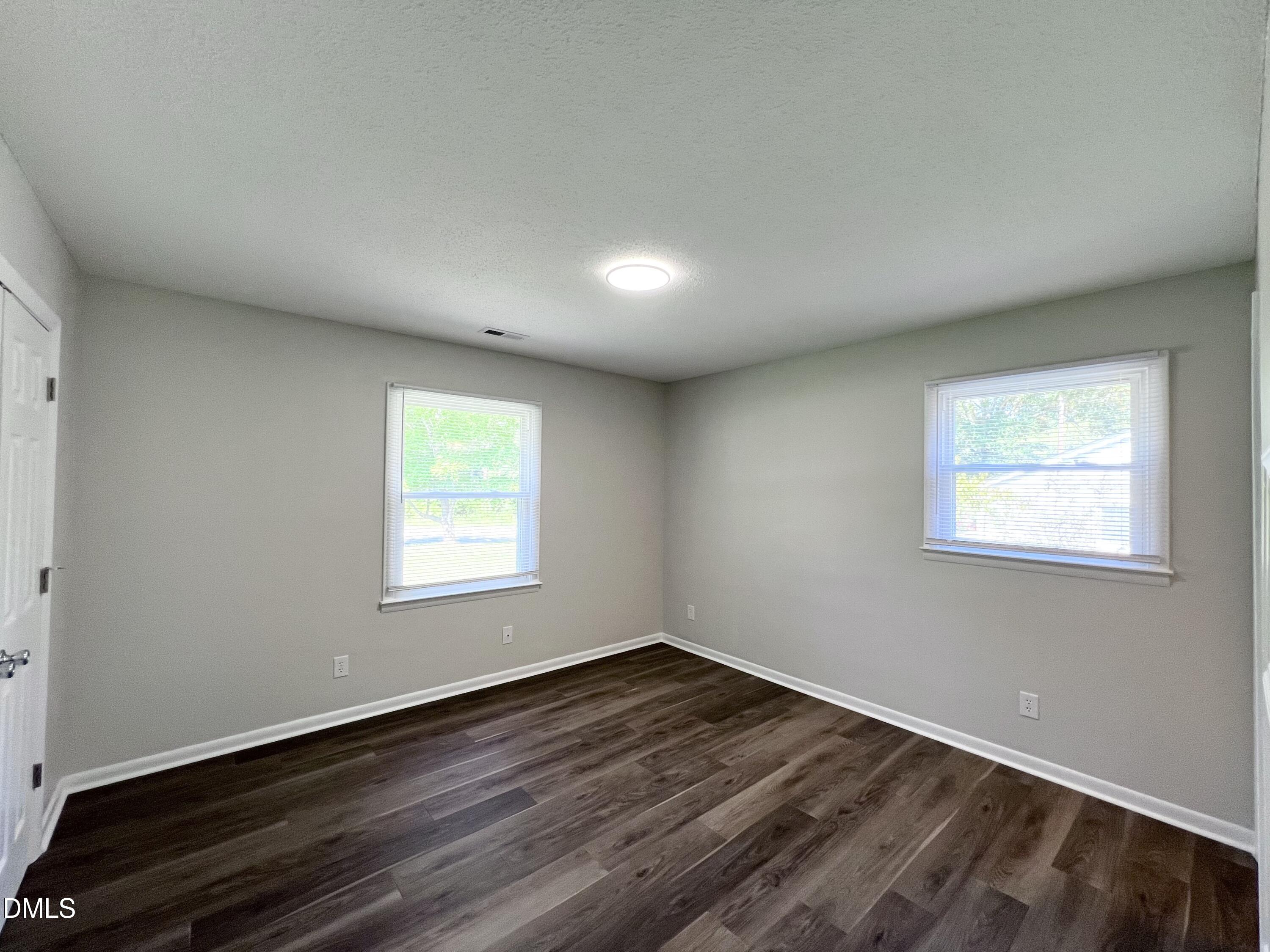 200 Infinity Road Durham, NC 27712 - Photo 24 of 32 an empty room with wooden floor and windows