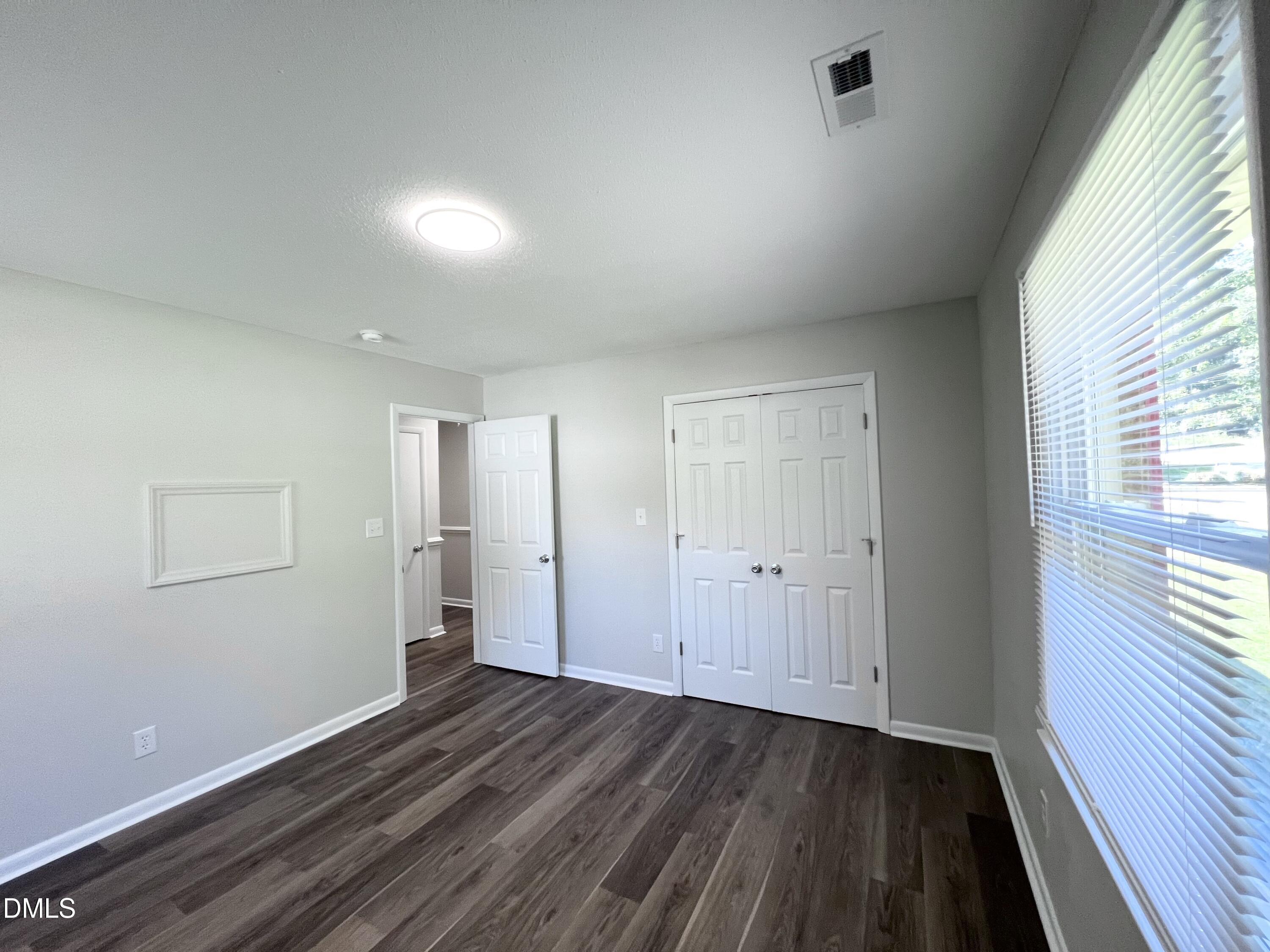 200 Infinity Road Durham, NC 27712 - Photo 25 of 32 wooden floor in an empty room with a window