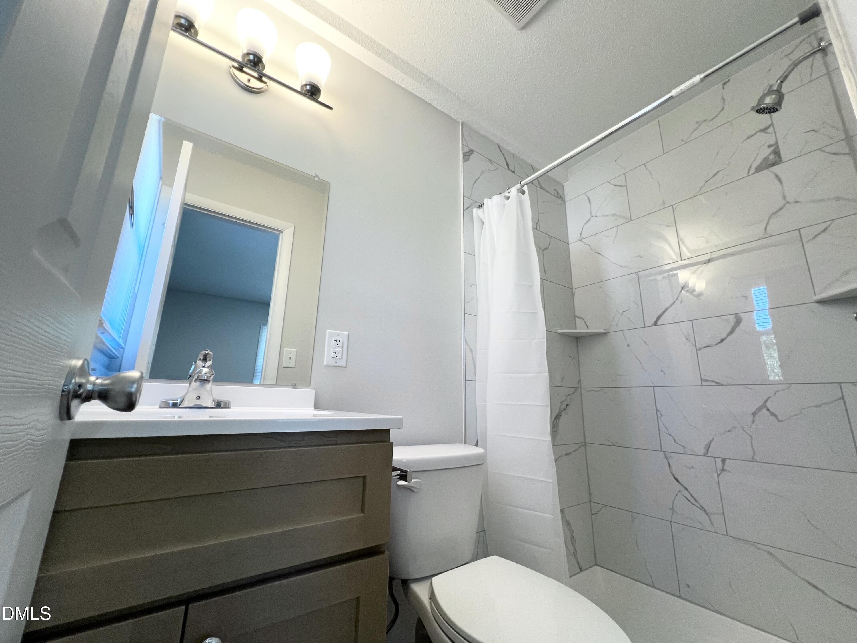 200 Infinity Road Durham, NC 27712 - Photo 28 of 32 a bathroom with a sink toilet and mirror