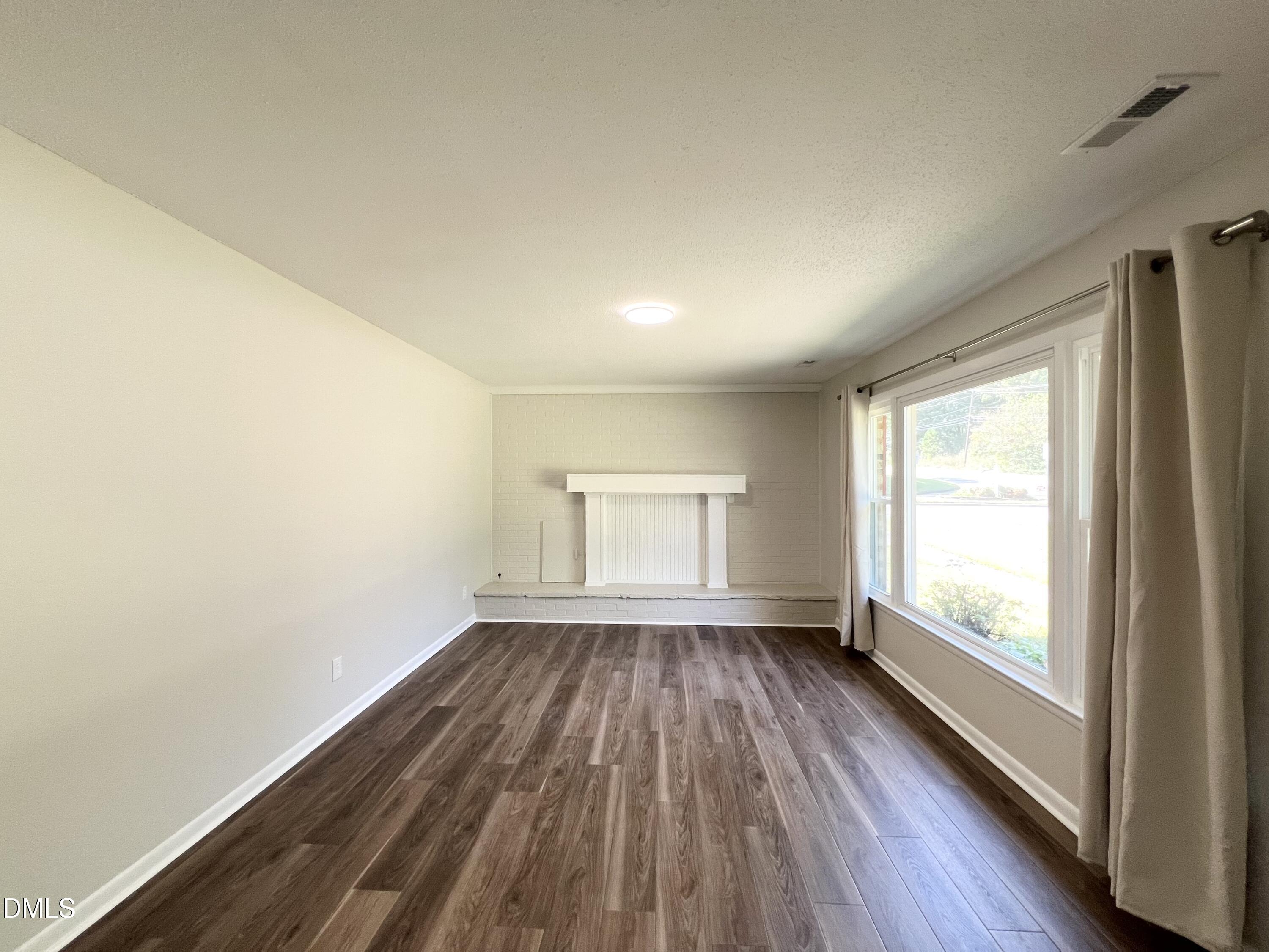 200 Infinity Road Durham, NC 27712 - Photo 5 of 32 an empty room with wooden floor and windows