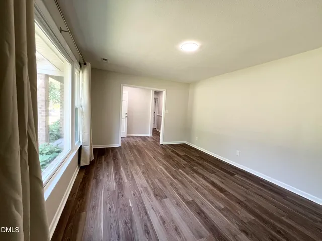 a view of an empty room and glass door