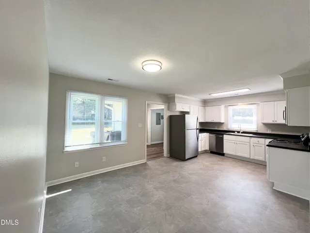 a view of a kitchen with a sink and stainless steel appliances