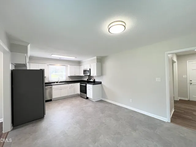 a kitchen with refrigerator and cabinets