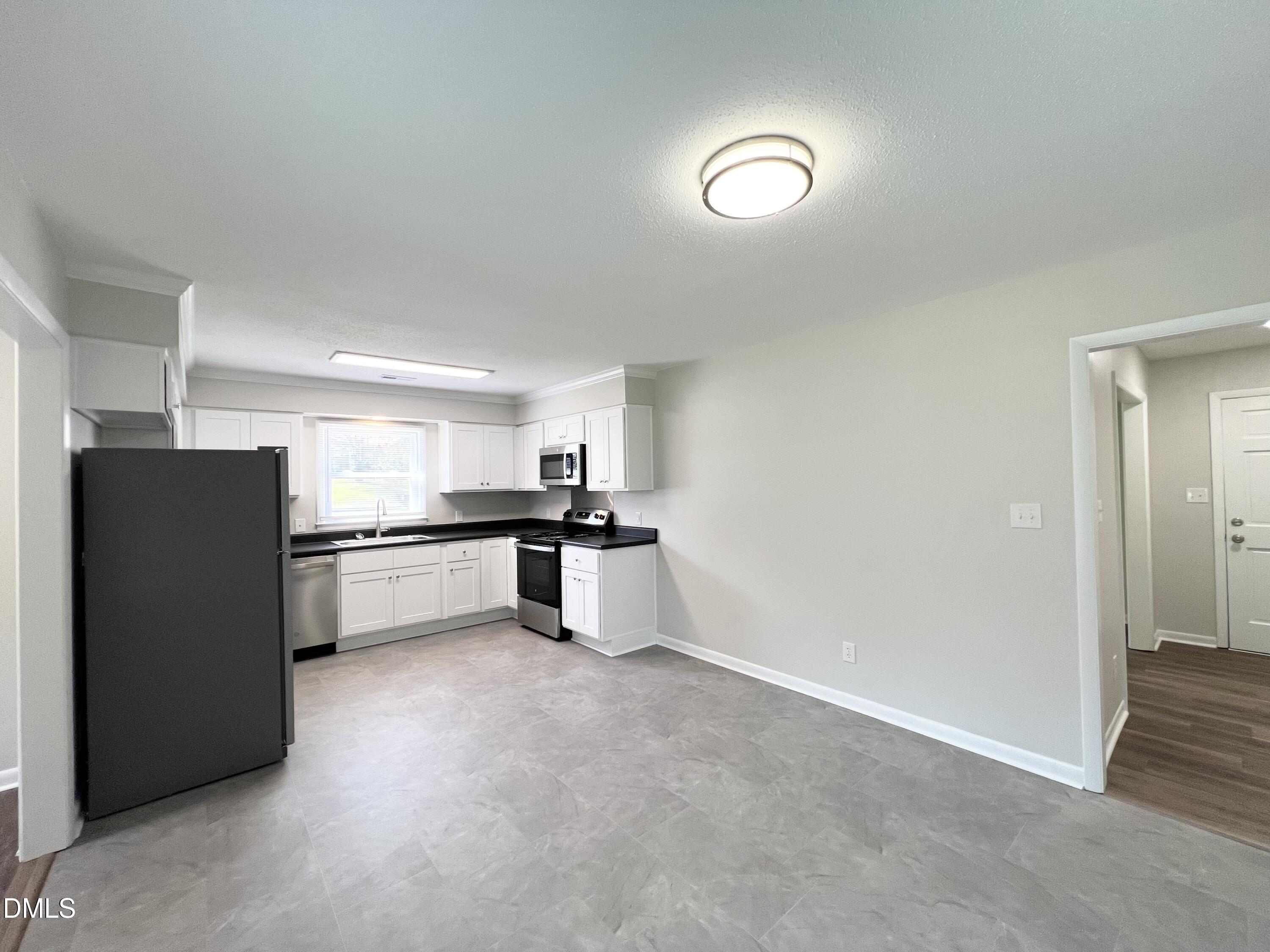 200 Infinity Road Durham, NC 27712 - Photo 9 of 32 a kitchen with refrigerator and cabinets