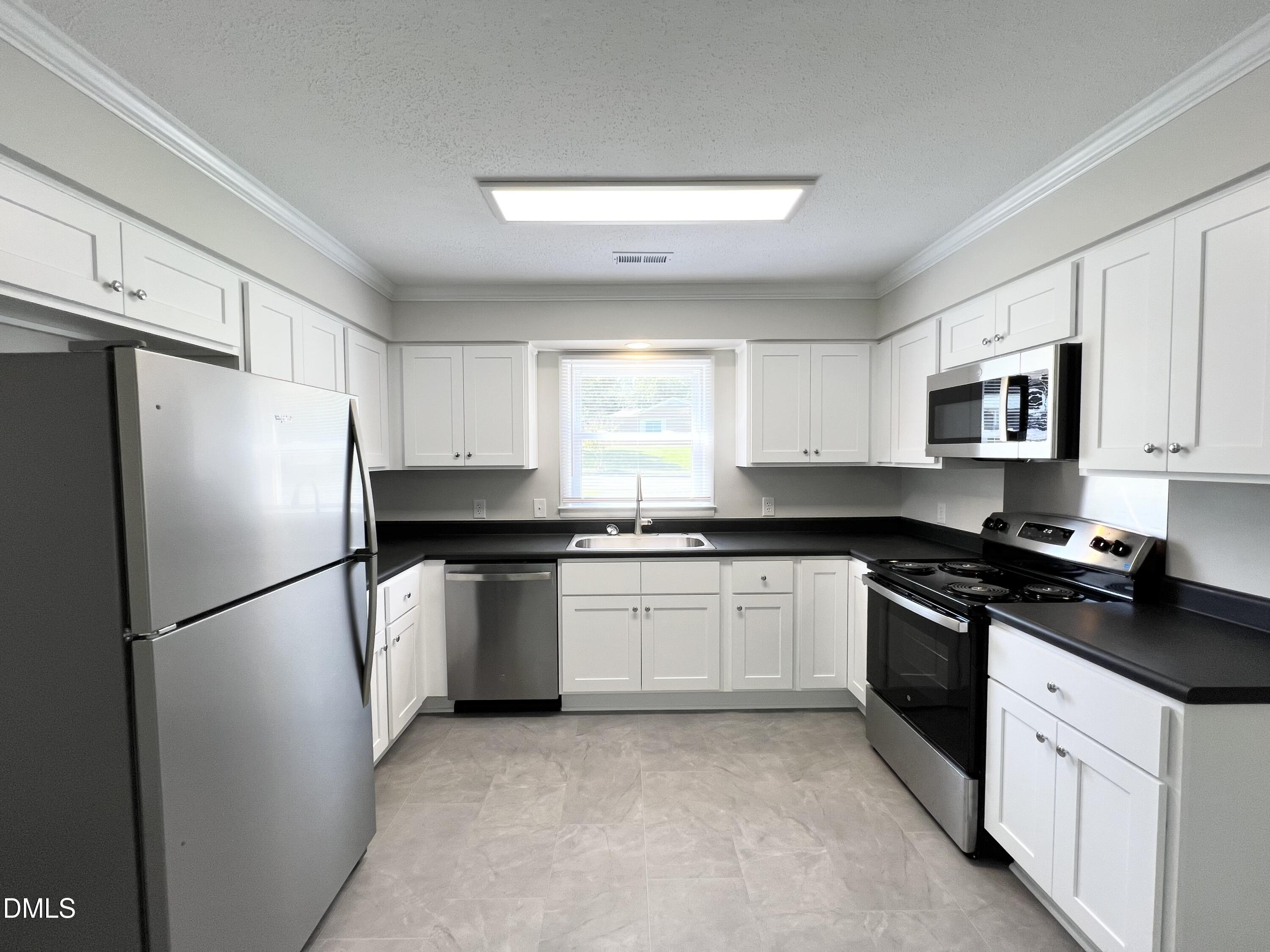 200 Infinity Road Durham, NC 27712 - Photo 10 of 32 a kitchen with granite countertop a refrigerator stove top oven and sink