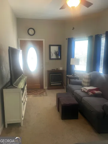 a view of a hallway with furniture and window