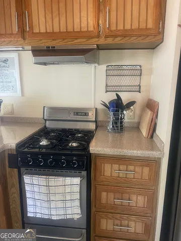 a kitchen with granite countertop a sink and a window