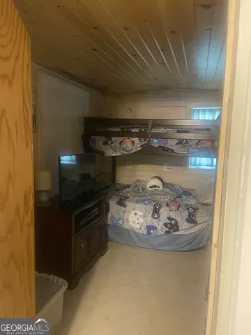 a bedroom with a bed and a mirror