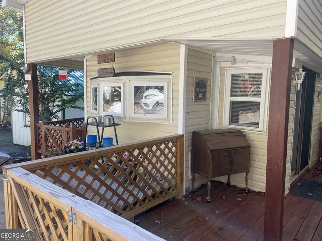 a view of a porch with furniture and wooden floor